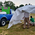 Volunteers clearing up in a thunderstorm